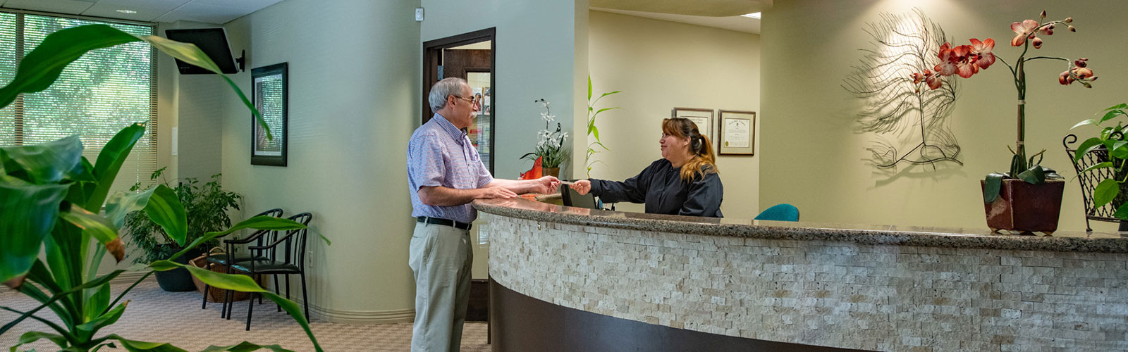 Bella Hanono Family Dentistry - front office staff talking to a patient