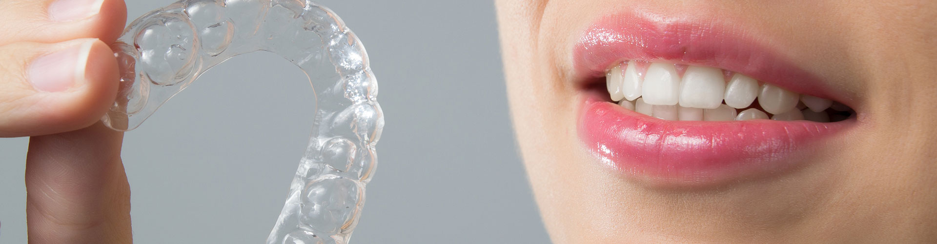 A woman holding a invisalign baught from Bella Hanono Family Dentistry